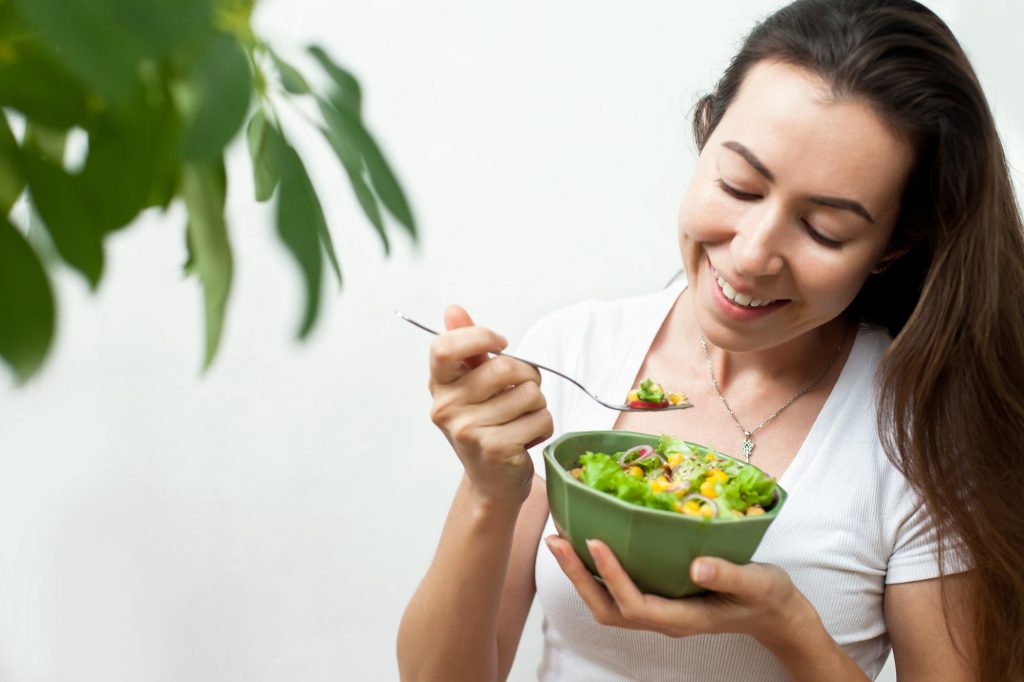 A Young Woman Eating A Salad; Eating Healthy Concept, Green, Plant Based Diet, Nutrition, Vegan, Eco